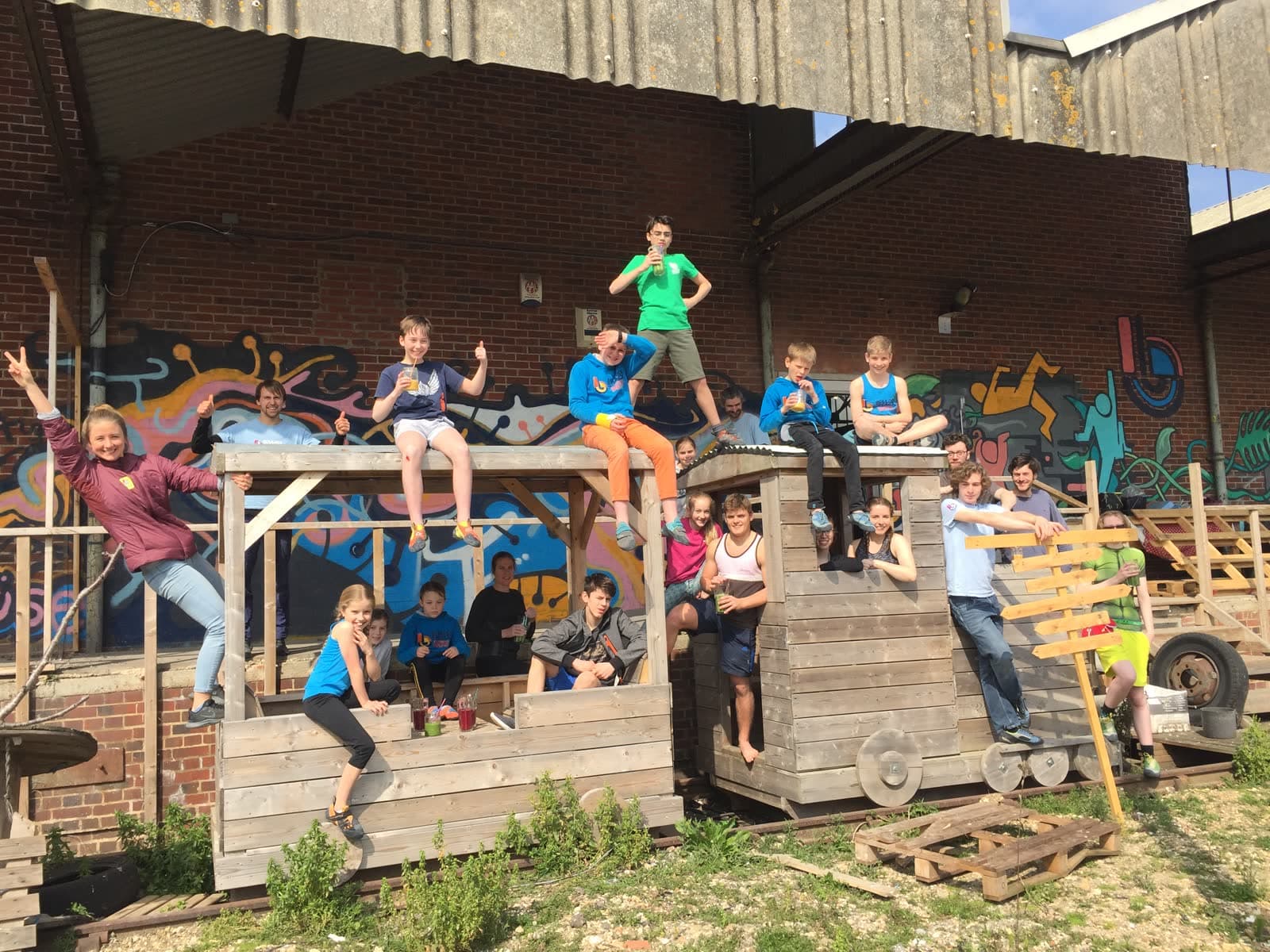 A big group of members and their families outside the Shack